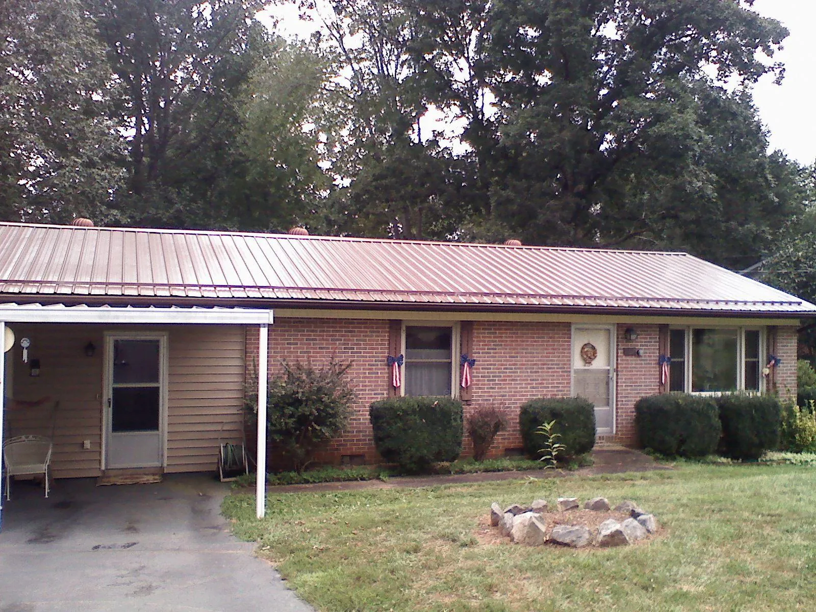 Bronze metal roof and carport on a brick ranch home — Roof Repair work by our crew in Cream Ridge